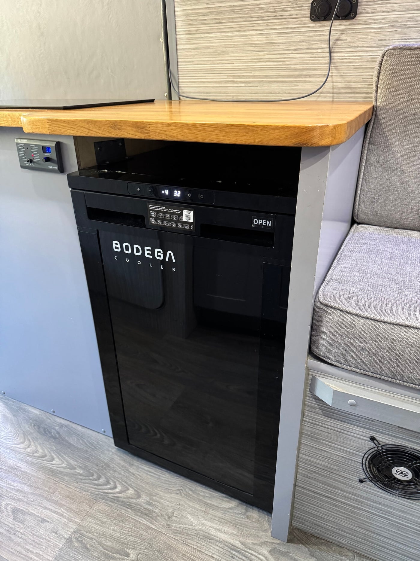  facing an open screen door with forest views.|Modern RV rental interior: dining area — photo 7