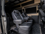 Luxurious RV rental interior with plush black captain's chairs, diamond stitching, and a built-in cooler for your journey.