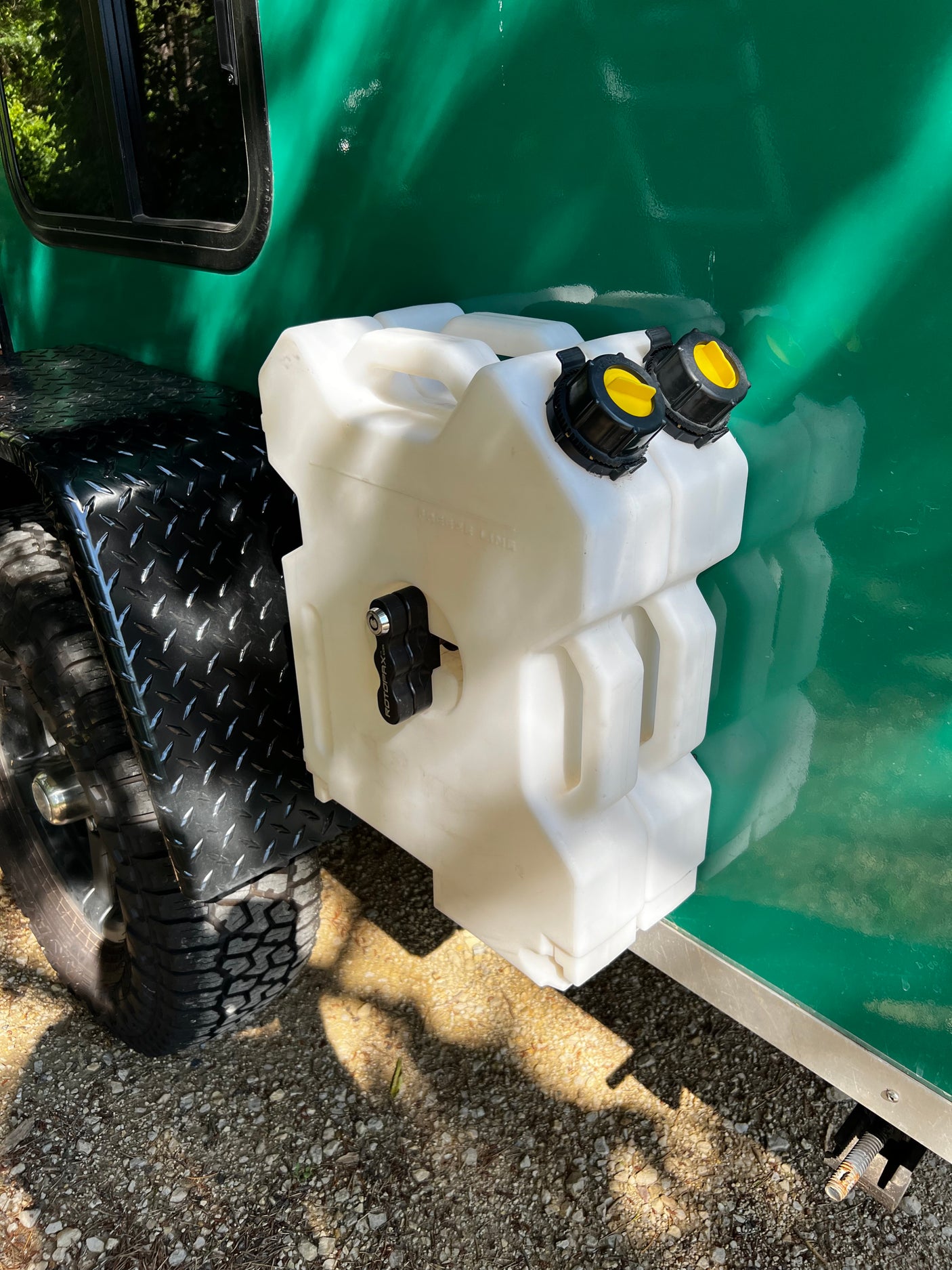 White RotopaX fuel/water can mounted on an RV rental. Ideal for off-grid adventures and travel needs.