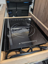 This RV rental features a convenient True Induction cooktop in a pull-out drawer, perfect for mobile cooking and camping.