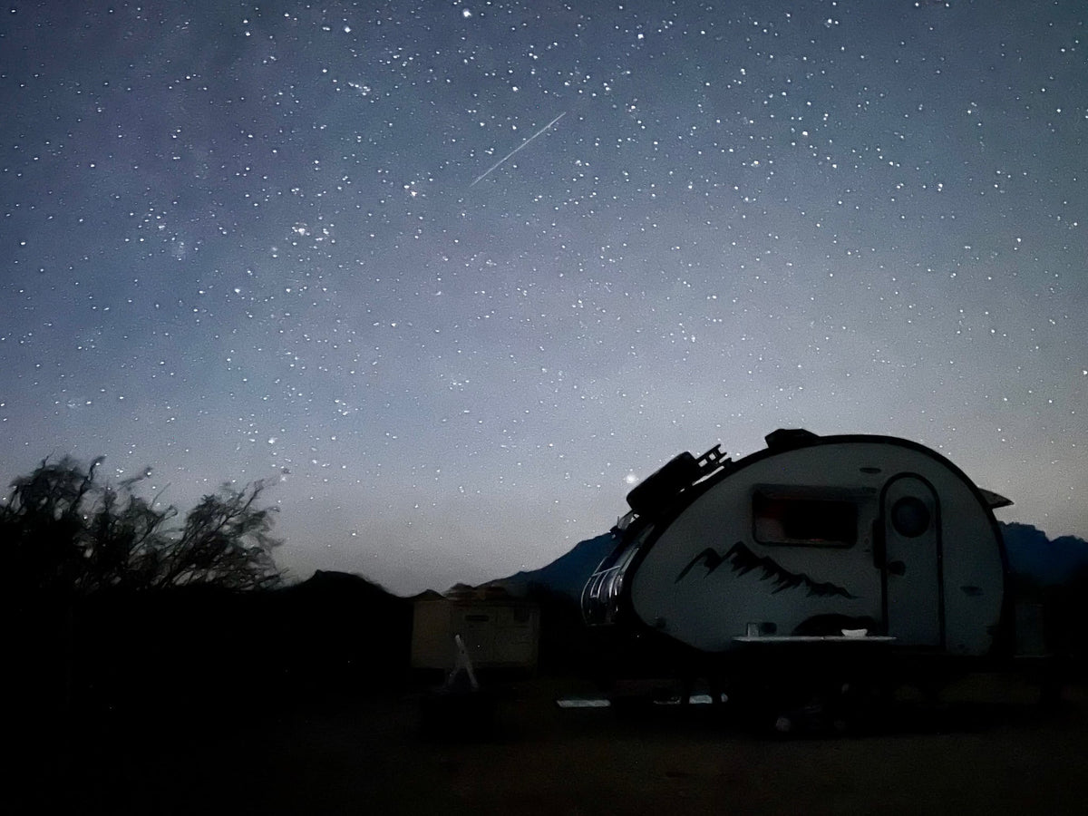 Beautiful starry night sky with a shooting star over an RV rental