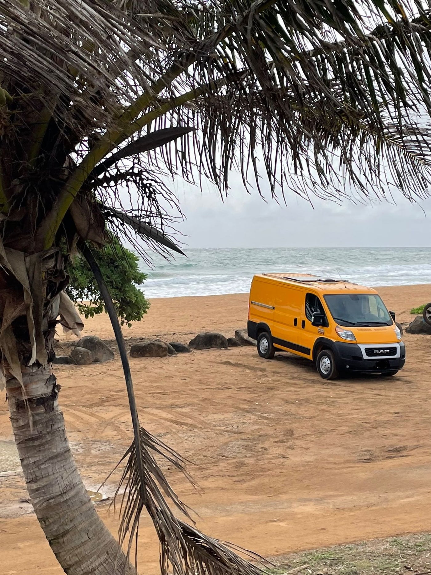  and blue side panels lead to a scenic beach view.|RV rental: Wide-angle view of the front cab of a customized camper van — photo 12