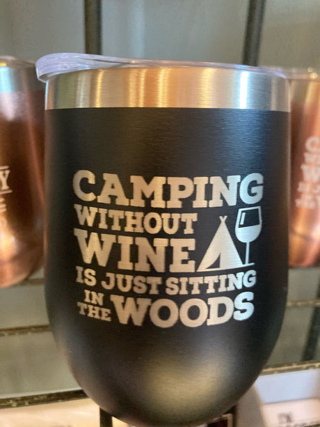A black travel tumbler reads: "Camping without wine is just sitting in the woods." Perfect for your RV rental trips!