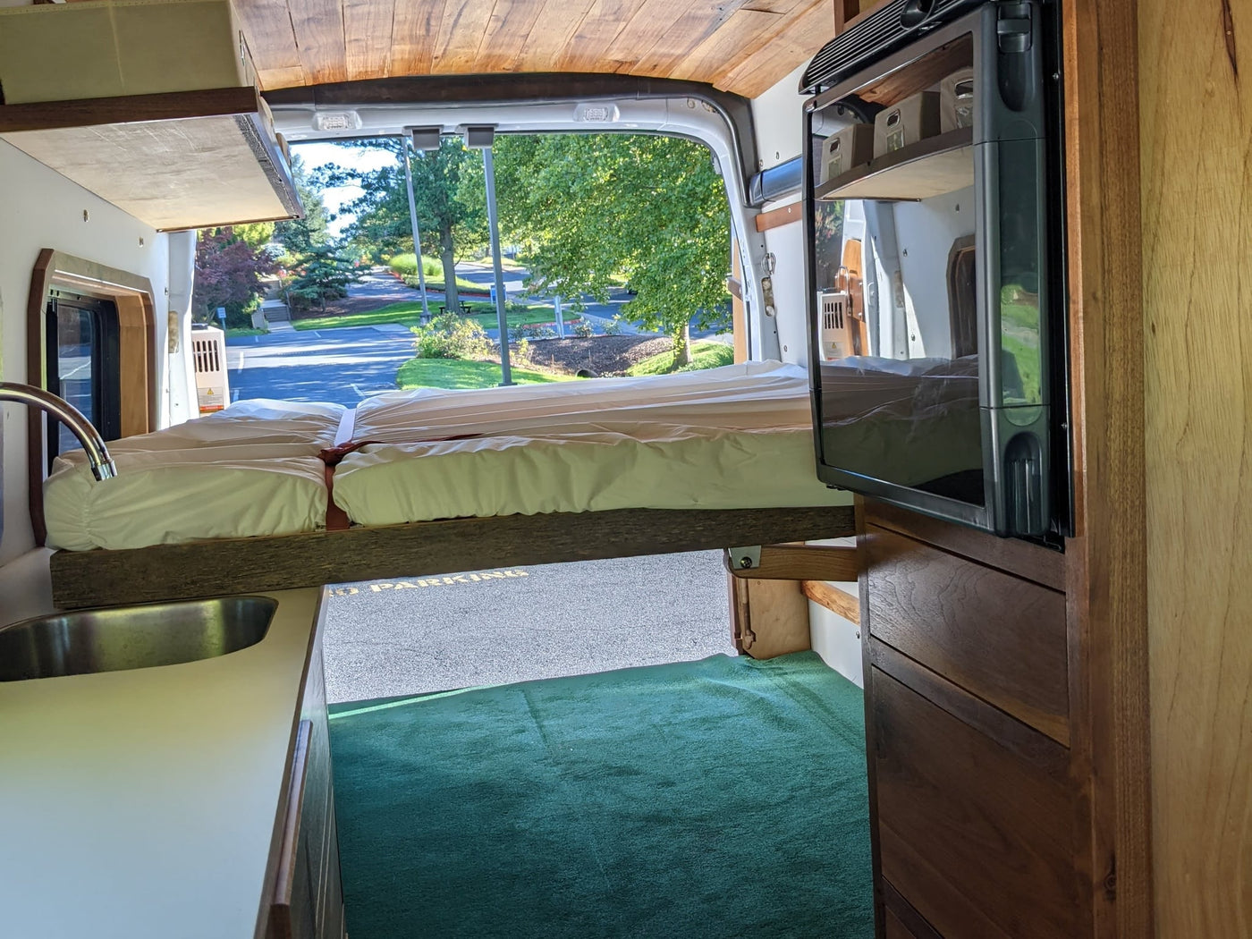  and a bright view of fields and trees.|This RV rental features a cozy kitchen with a pull-out stove — photo 16