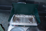 RV rental essentials: A Coleman two-burner propane camping stove, open and ready for outdoor cooking.