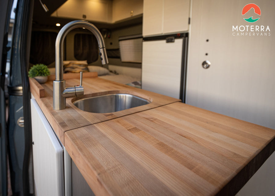  enjoying the scenic desert outdoors.|RV rental campervan kitchen: a modern sink
