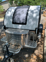 This white compact teardrop RV, available for RV rental, features a front diamond-plate storage box and large window.