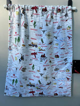 A vibrant fabric curtain displaying an illustrated US map with states & landmarks, a charming addition for an RV rental.