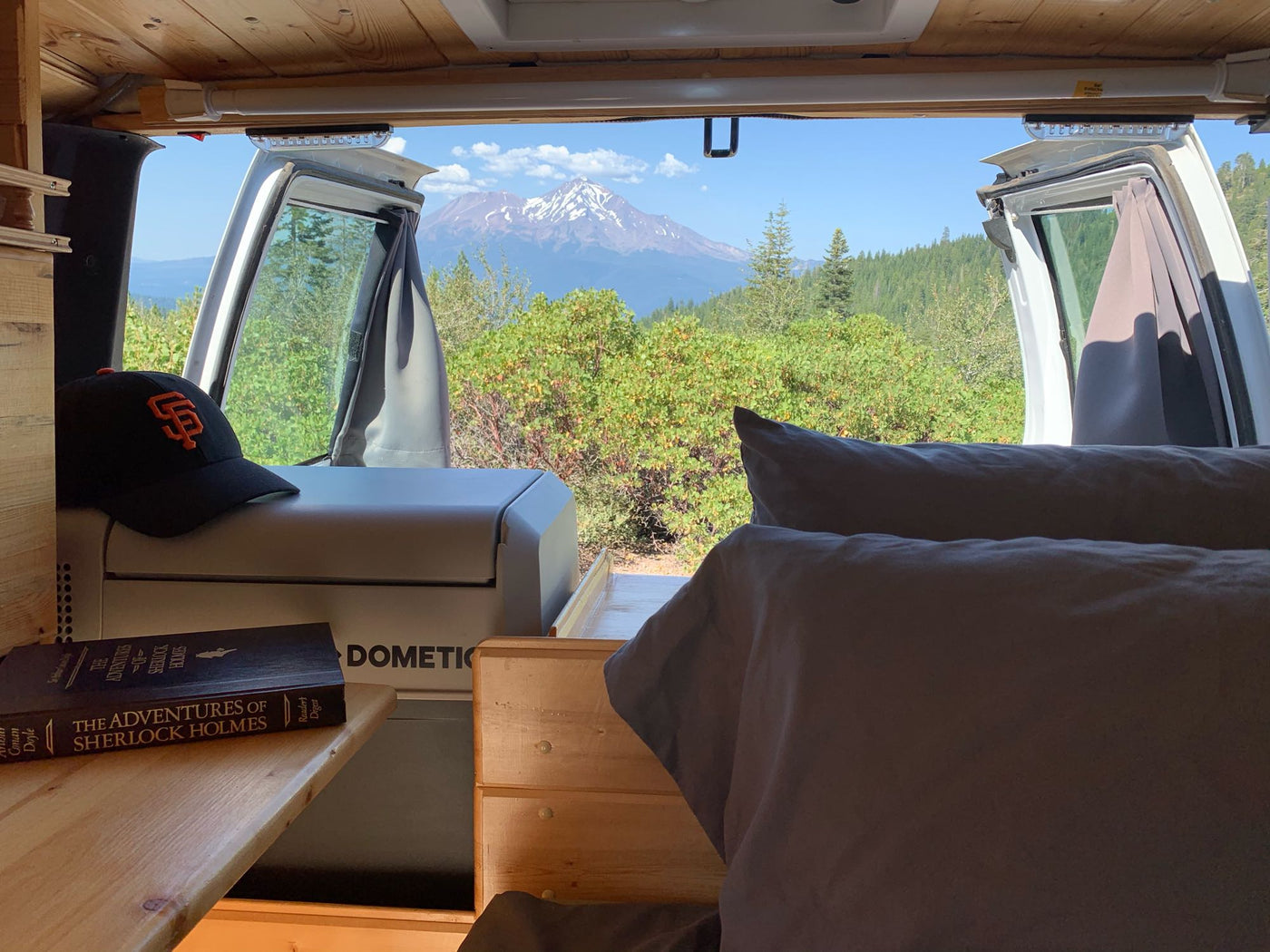  perfect for outdoor adventures.|RV rental interior: custom wooden build with bed — photo 6