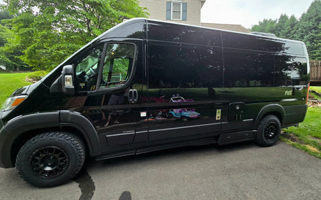  and scenic outdoor views from large windows.|This cozy RV rental features a versatile camper van interior with a comfortable bed/seating area and ample storage.|Inside a modern rv rental camper van