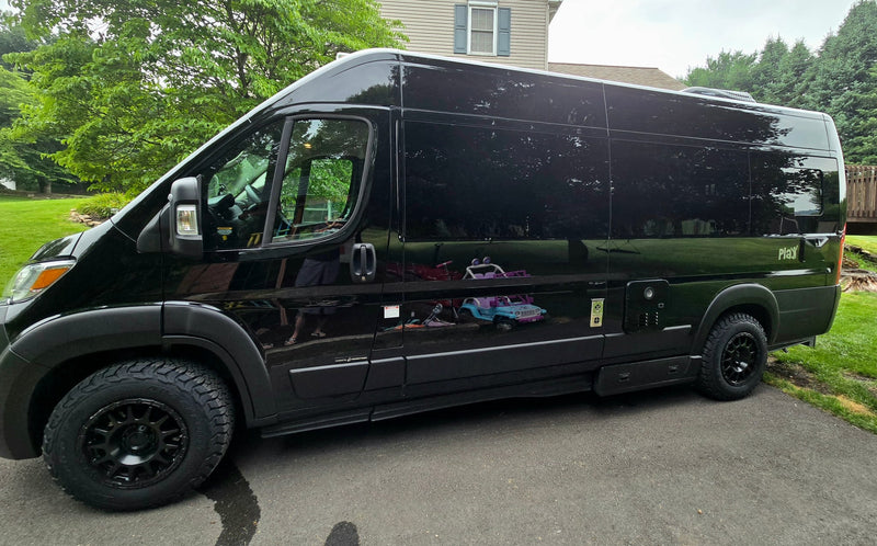  and scenic outdoor views from large windows.|This cozy RV rental features a versatile camper van interior with a comfortable bed/seating area and ample storage.|Inside a modern rv rental camper van — photo 15