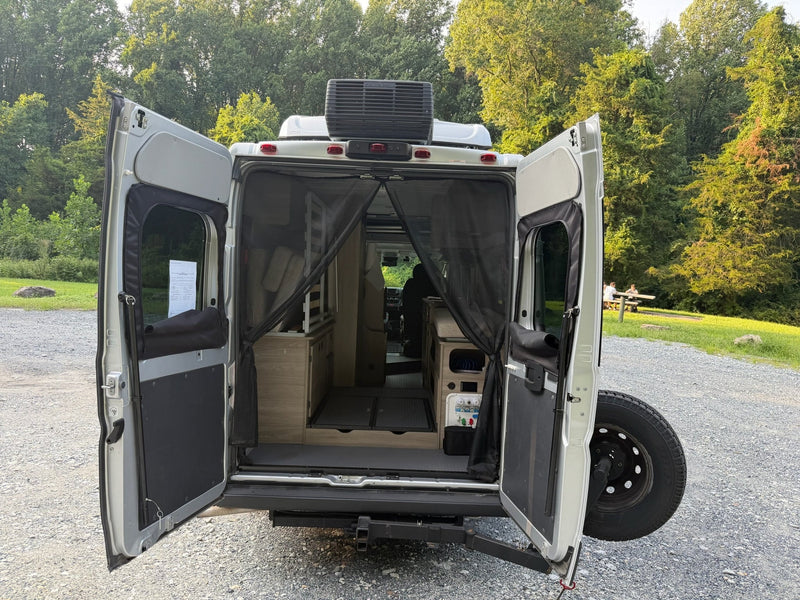  and front seats. Ready for comfortable travel and dining.|RV rental interior with two light quilted seats — photo 18