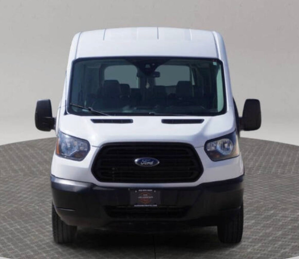 Front view of a white Ford Transit van on a turntable, excellent for rv rental conversions, cargo, or utility use.