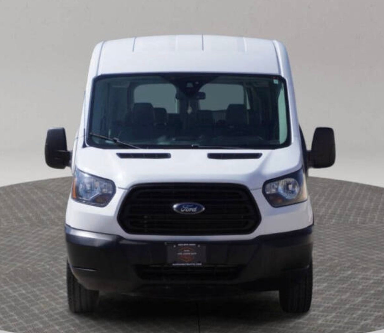  a practical choice for your next RV rental.|Front view of a white Ford Transit van on a turntable — photo 2