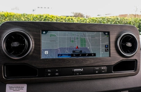 RV rental's infotainment system dashboard, displaying a navigation map to "Addison," air vents, and media controls.