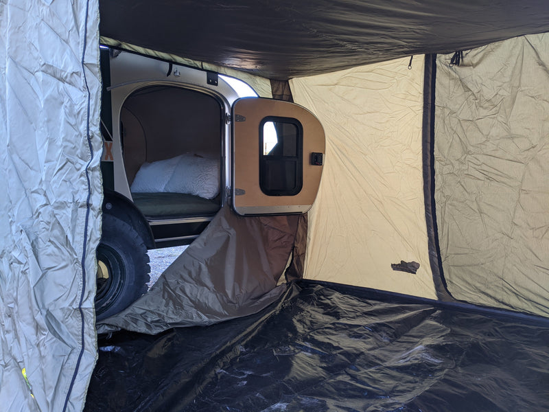 Teardrop camper's attached annex tent with an open door to the sleeping area, ideal for an RV rental adventure. — photo 16