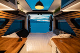 Cozy **RV rental** interior with a stunning lake and mountain view from the back. Perfect for travel adventures.