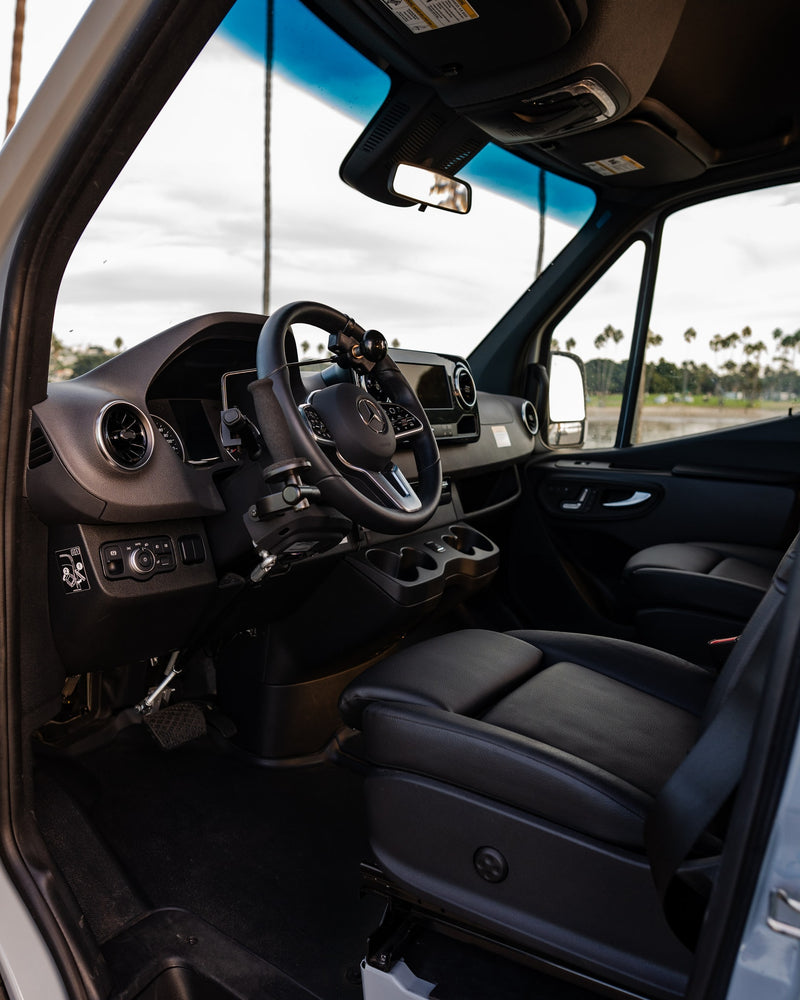  and water view.|RV rental cockpit with Mercedes steering wheel & accessibility modifications — photo 11