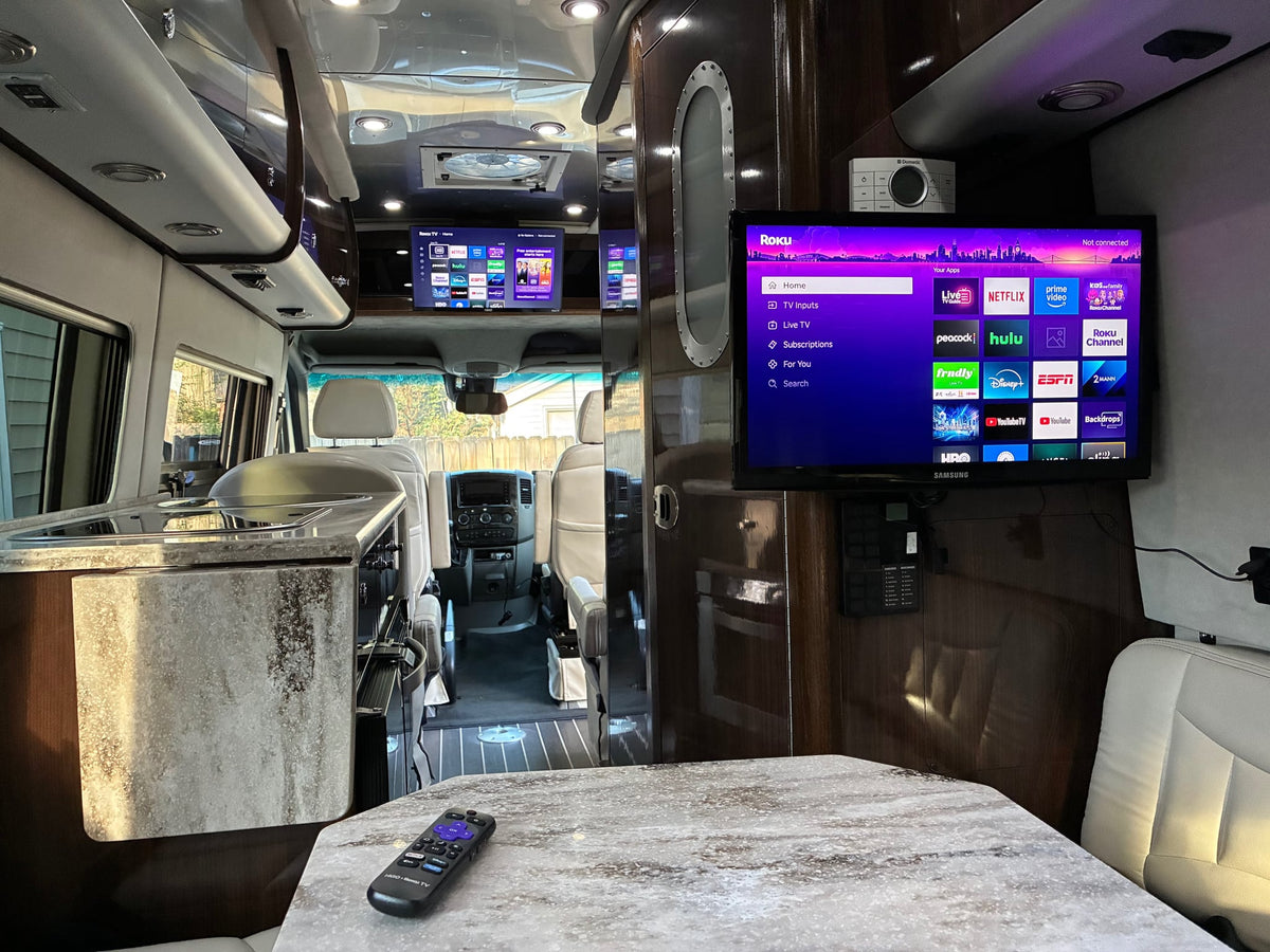  and shiny wood panels. Control panel visible.|RV rental interior: light beige seating — photo 4