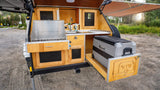 Experience convenient outdoor cooking with this RV rental's built-in kitchen: stove, sink, and pull-out Alpicool fridge for camping.