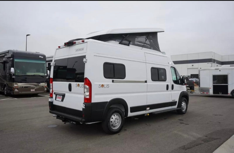  parked on a driveway under a clear blue sky.|RV rental floor plan for model 59P: adaptable interior showing bed/sofa — photo 4