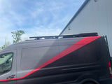 Stylish gray & black camper van with a red stripe, roof rack, & rear ladder, parked by a building. Ideal for your RV rental adventure.