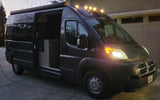 Explore in style! This modern grey camper van, ready for an RV rental adventure, shows its interior with lights on.