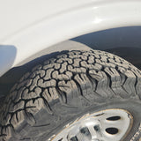 Visually impaired users: A worn, dry-rotted tire on an RV rental. Tread shows deep cracks, highlighting maintenance needs.