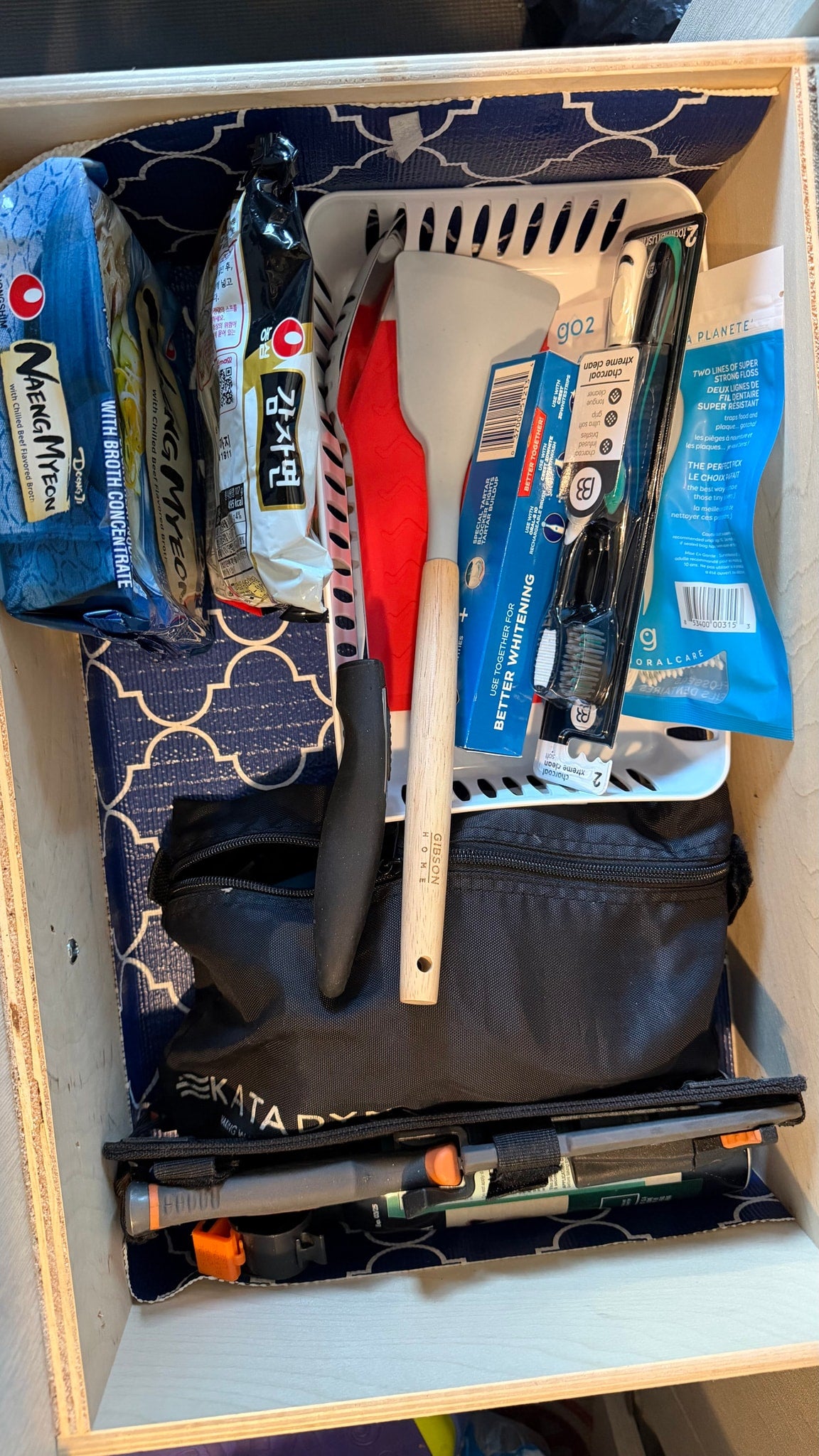  revealing an installed black mesh screen. A roof AC unit and tow hitch are visible.|Organized kitchen supplies in an RV rental drawer: condiments — photo 17