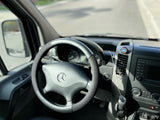 RV rental interior: Mercedes-Benz steering wheel, dashboard, and a Captain America shield emblem.