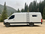 Explore the outdoors in this rugged white Mercedes Sprinter camper van, a great RV rental for mountain adventures.