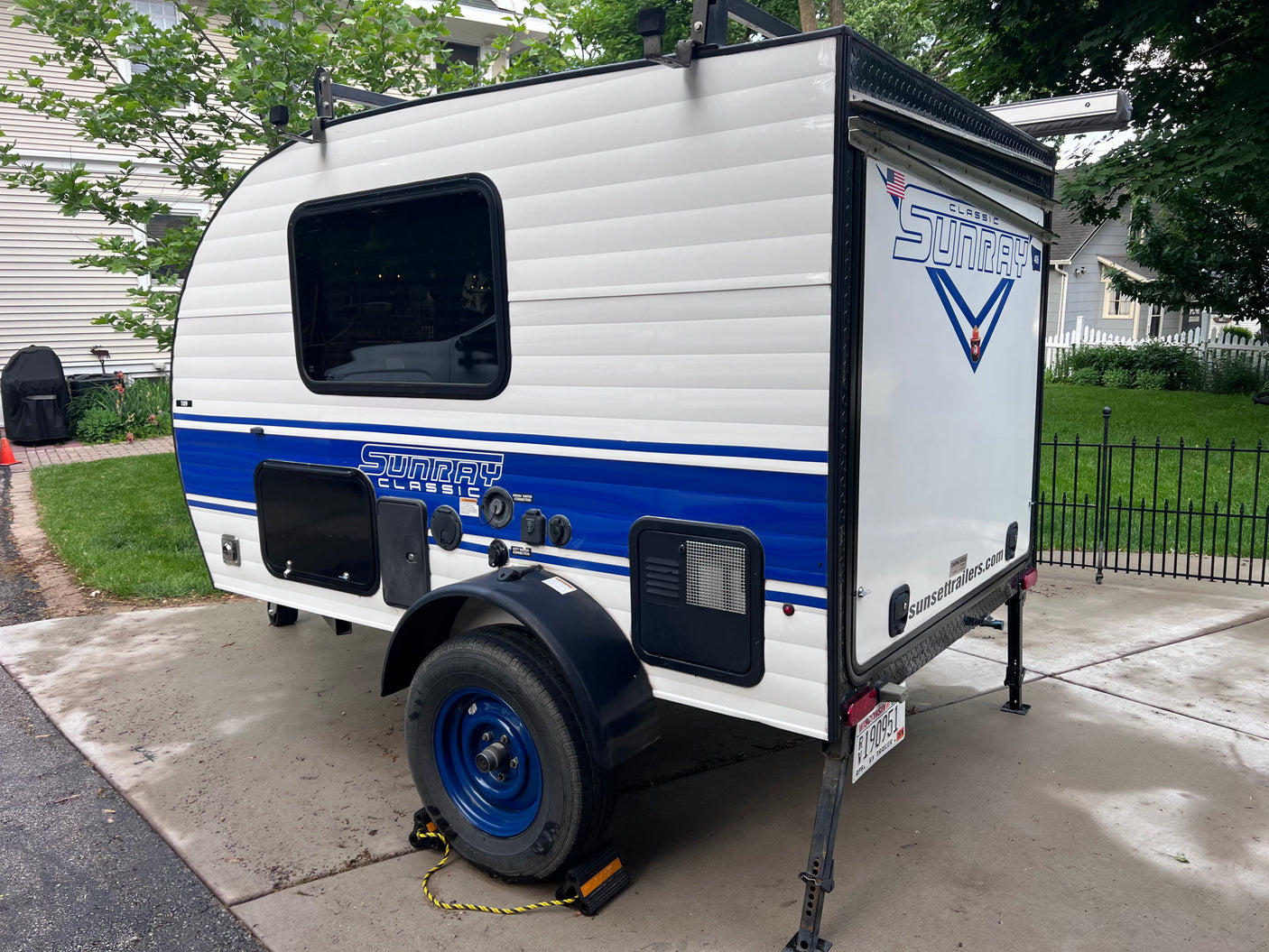 This white & blue Sunray Classic teardrop RV trailer by Sunset is ideal for an rv rental or camping trip.