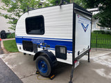 This white & blue Sunray Classic teardrop RV trailer by Sunset is ideal for an rv rental or camping trip.