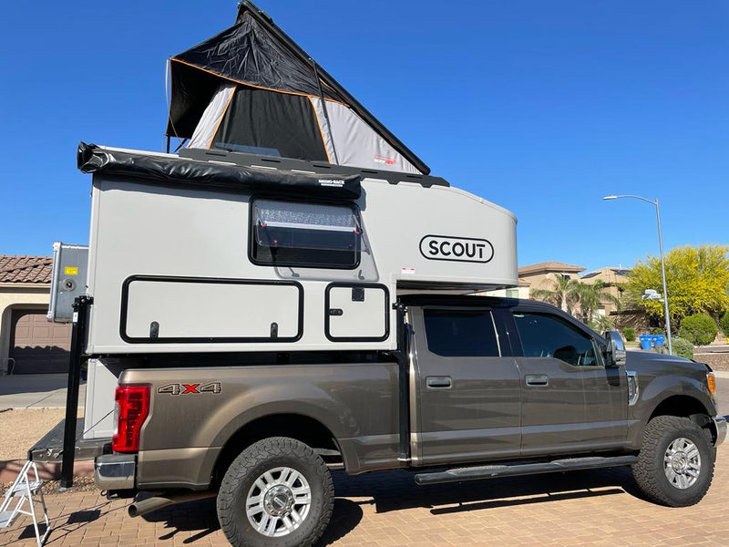  a Ford pickup with a light-colored truck camper — photo 3