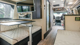 Step into this elegant RV rental! Interior boasts plush quilted seating, a mounted TV, adjustable table, and functional amenities.