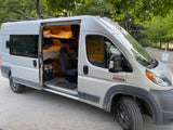 Explore with this Ram ProMaster rv rental. Custom camper van features wood interior, bunk beds, and roof racks.
