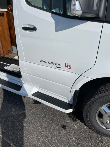 White "GALLERIA Li3" RV rental side view with open door and steps. Ideal for a comfortable road trip.