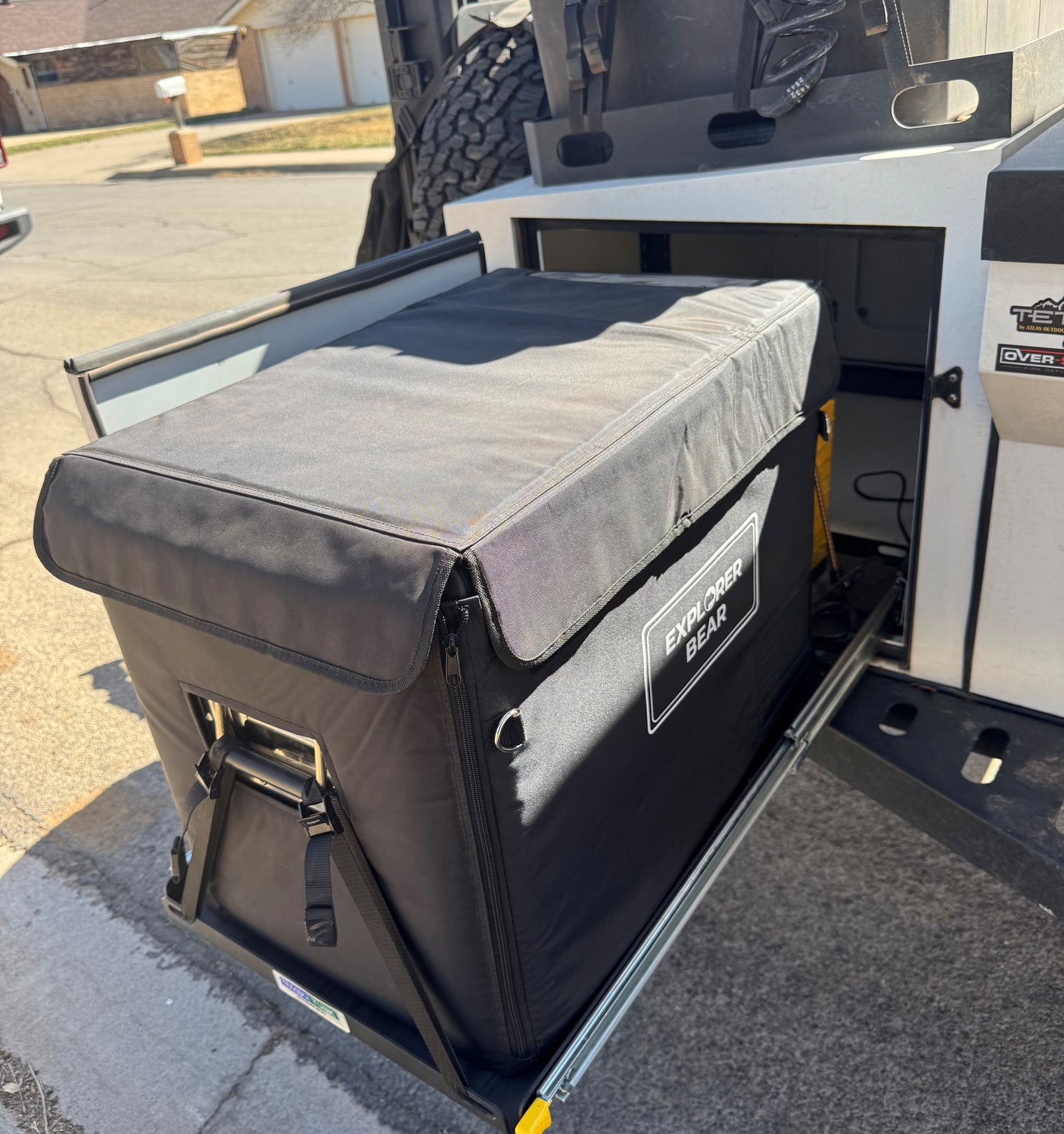 Explorer Bear cooler on an RV rental pull-out tray for easy access during camping trips.
