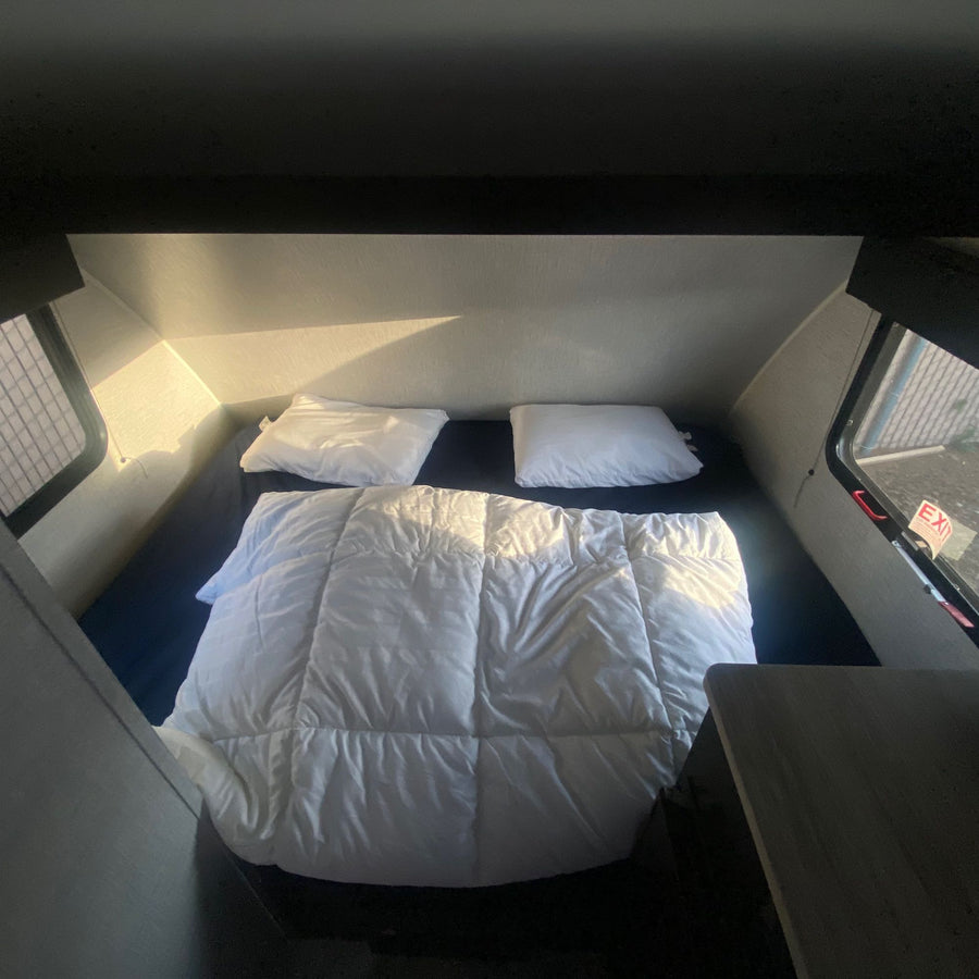  and rear taillight.|RV rental interior featuring a dinette with a light wood table