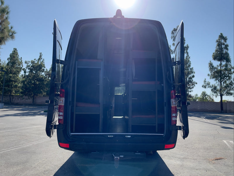 Rear view of an RV rental van with open doors, showing multiple bunk beds inside. — photo 17