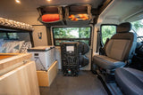 RV rental interior: cozy camper van setup with bunk bed, portable fridge, versatile seating, & overhead storage.