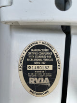 Close-up of an rv rental's RVIA certification, detailing compliance for electrical, plumbing, heating, and fire safety.