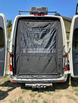 Rear of an RV rental camper van, doors open, showing a black privacy screen with mesh window, ready for adventure.