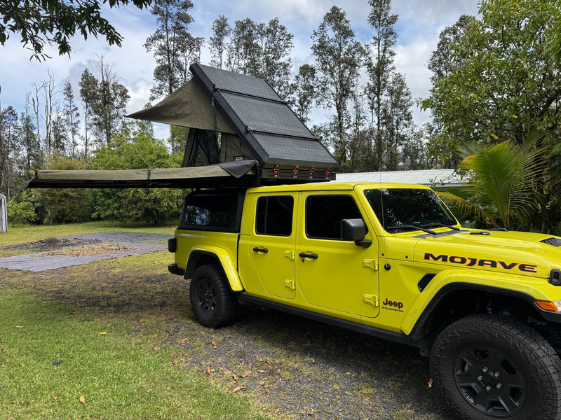 Yellow Jeep Gladiator with an open rooftop tent & awning. Great for an RV rental camping adventure. — photo 8