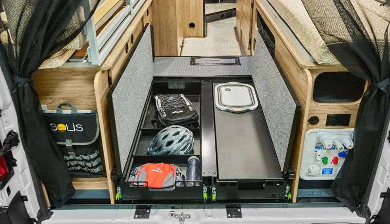  and a small wall-mounted storage shelf.|Inside a modern RV rental: compact kitchen with two-burner stove — photo 12