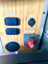 RV rental electrical panel featuring USB-C ports, 12-volt socket, and a house battery disconnect switch for onboard power control.