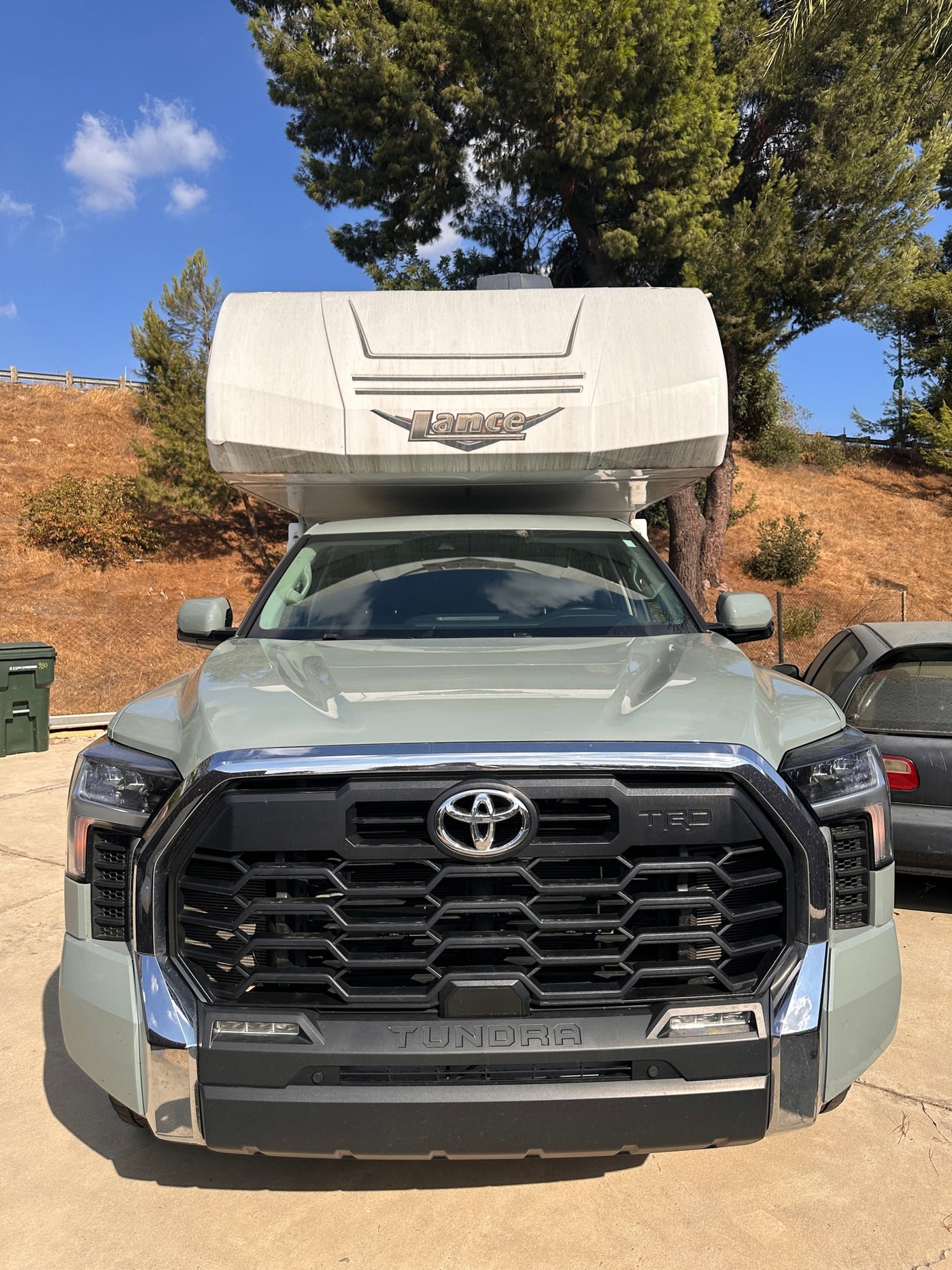  ready for travel under a bright sky.|This white Lance truck camper — photo 9