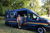  grassy park.|Dark gray camper van for RV rental