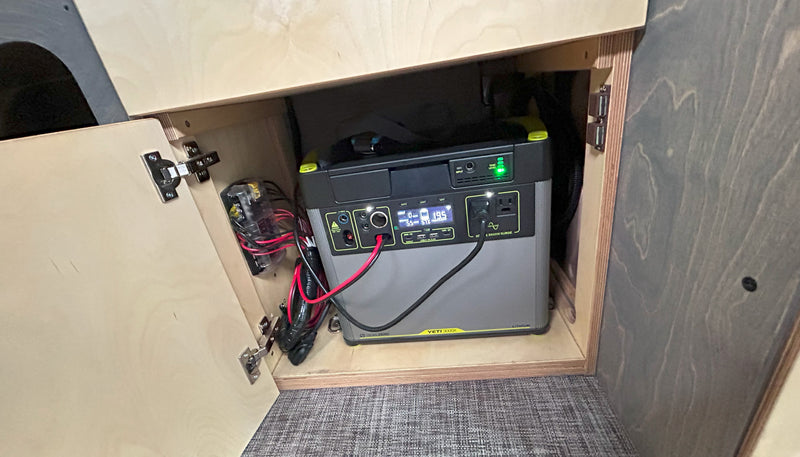 Compact power for your RV rental: Goal Zero Yeti 3000X portable power station, wires, and fuse box neatly in cabinet. — photo 13