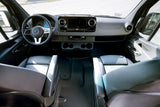 Inside an RV rental Mercedes-Benz Sprinter van, showing the cockpit, steering wheel, dashboard, and front seats.